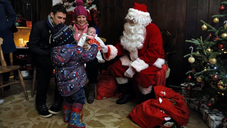Families meeting Father Christmas at Trelissick, Cornwall